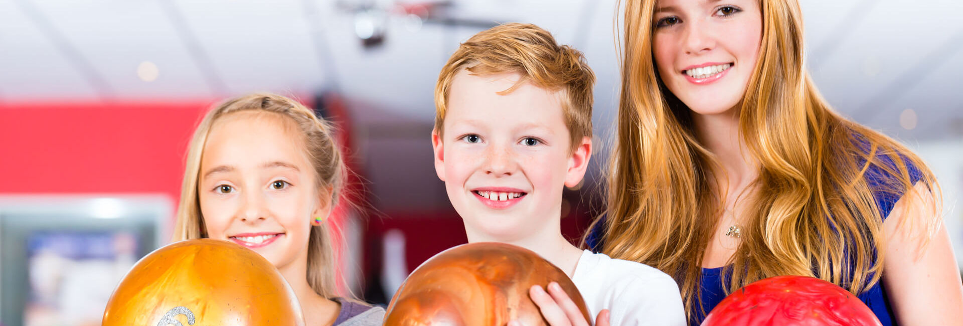 Children and teenager play bowling